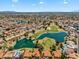 Community aerial view with golf course, pond, and well-maintained residential area at 19920 N 69Th Ave, Glendale, AZ 85308