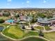 Gorgeous aerial view of the community amenities featuring a pool, golf course, tennis courts, and clubhouse at 19920 N 69Th Ave, Glendale, AZ 85308