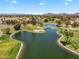 Picturesque aerial view of golf course with a bridge over a scenic lake in a residential area at 19920 N 69Th Ave, Glendale, AZ 85308