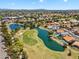 Aerial view showcasing the golf course community with lush greenery, lake, and beautiful homes at 19920 N 69Th Ave, Glendale, AZ 85308