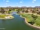 Scenic aerial view of the community golf course with a beautiful lake and homes at 19920 N 69Th Ave, Glendale, AZ 85308
