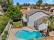 Aerial view of a backyard pool, patio, and balcony, showcasing desert landscaping at 19920 N 69Th Ave, Glendale, AZ 85308