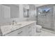 Elegant bathroom featuring marble countertops, dual sinks, and a luxurious glass-enclosed shower with designer tile at 19920 N 69Th Ave, Glendale, AZ 85308