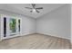 Bedroom features a ceiling fan and sliding glass doors that allow natural light at 19920 N 69Th Ave, Glendale, AZ 85308