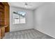 This bedroom features neutral carpet, ceiling fan, and a window with natural light at 19920 N 69Th Ave, Glendale, AZ 85308