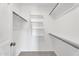 Spacious walk-in closet with multiple shelves, hanging rods, and carpeted floor for maximum storage convenience at 19920 N 69Th Ave, Glendale, AZ 85308