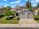 Charming two-story home featuring a three-car garage, manicured lawn, and mature trees at 19920 N 69Th Ave, Glendale, AZ 85308