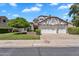 Charming two-story home featuring a three-car garage, manicured lawn, and beautiful curb appeal at 19920 N 69Th Ave, Glendale, AZ 85308