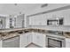 Updated kitchen showcases granite counters, stainless appliances, and white cabinets at 19920 N 69Th Ave, Glendale, AZ 85308