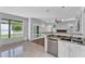 Modern kitchen with stainless appliances, granite counters, and open layout into the living space at 19920 N 69Th Ave, Glendale, AZ 85308