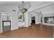 Bright living room featuring hardwood floors, neutral walls, a decorative chandelier, and plentiful natural light at 19920 N 69Th Ave, Glendale, AZ 85308