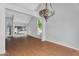 Bright living room featuring hardwood floors, neutral walls, a decorative chandelier, and plentiful natural light at 19920 N 69Th Ave, Glendale, AZ 85308