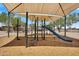 A modern playground with a shade structure, climbing ropes, and a slide at 19920 N 69Th Ave, Glendale, AZ 85308