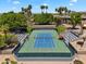 Beautiful aerial view of a blue and green tennis court framed by towering palms and lush trees at 19920 N 69Th Ave, Glendale, AZ 85308
