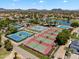 Aerial image highlighting the community's well-maintained tennis courts surrounded by mature landscaping and lush greenery at 19920 N 69Th Ave, Glendale, AZ 85308
