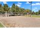 A sand volleyball court with a net in a park with trees and clear blue skies at 19920 N 69Th Ave, Glendale, AZ 85308
