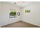 Bright bedroom features neutral carpet, two windows for ample natural light, and a modern ceiling fan at 20750 N 87Th St # 1024, Scottsdale, AZ 85255