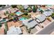 A bird's eye view shows a sparkling pool with a desert landscape, solar panels, and neighboring community pools at 2139 W Obispo Ave, Mesa, AZ 85202