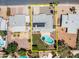 An aerial view shows a backyard swimming pool, lush grass, desert landscaping, and solar panels on the gray roof at 2139 W Obispo Ave, Mesa, AZ 85202