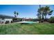 A lush green backyard features a sparkling swimming pool with a covered patio perfect for relaxing and entertaining guests at 2139 W Obispo Ave, Mesa, AZ 85202