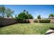 Spacious backyard with lush green lawn, mature trees, and a brick perimeter fence at 2139 W Obispo Ave, Mesa, AZ 85202