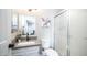 Bathroom featuring a vanity, stone countertop, modern faucet, and glass door shower at 2139 W Obispo Ave, Mesa, AZ 85202