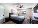 Bedroom featuring a ceiling fan, natural light, bedside tables, and modern accents at 2139 W Obispo Ave, Mesa, AZ 85202