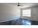 Bedroom with neutral paint, ceiling fan, large window and sleek epoxy flooring at 2139 W Obispo Ave, Mesa, AZ 85202