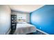 Bedroom featuring a modern accent wall, natural light, bedside tables, and carpet floors at 2139 W Obispo Ave, Mesa, AZ 85202