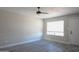 Bedroom with neutral paint, ceiling fan, large window and luxury vinyl plank flooring at 2139 W Obispo Ave, Mesa, AZ 85202