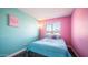 Cozy bedroom with blue bedding and a pink accent wall, offering a cheerful and bright space at 2139 W Obispo Ave, Mesa, AZ 85202