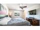 Bedroom featuring a ceiling fan, natural light, bedside tables, and modern accents at 2139 W Obispo Ave, Mesa, AZ 85202