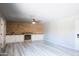 Bright living room with wood accent wall, fireplace, built-in cabinets, ceiling fan and luxury vinyl plank flooring at 2139 W Obispo Ave, Mesa, AZ 85202