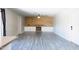 Bright living room with fireplace, wood accent wall, built-in cabinets, ceiling fan and luxury vinyl plank flooring at 2139 W Obispo Ave, Mesa, AZ 85202
