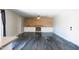 Bright living room with fireplace, wood accent wall, built-in cabinets, ceiling fan and sleek epoxy flooring at 2139 W Obispo Ave, Mesa, AZ 85202