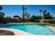 Refreshing pool with a view of palm trees, surrounded by a well-maintained yard with stone border at 2139 W Obispo Ave, Mesa, AZ 85202