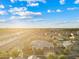 Wide aerial shot of a beautiful Primary-planned community with mountain views in the distance at 21912 E Desert Hills Dr, Queen Creek, AZ 85142