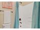Cozy bathroom features a shower with a blue shower curtain and neutral colored walls at 21912 E Desert Hills Dr, Queen Creek, AZ 85142
