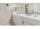 Bright, neutral bathroom featuring an extra-long vanity with double sinks and wall mirror at 21912 E Desert Hills Dr, Queen Creek, AZ 85142