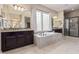 Bathroom with soaking tub featuring and sinks and a walk-in shower with glass doors at 21912 E Desert Hills Dr, Queen Creek, AZ 85142