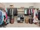 Walk-in closet with custom shelving, multiple hanging rods, and ample storage space at 21912 E Desert Hills Dr, Queen Creek, AZ 85142