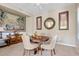 Formal dining room with round wood table, upholstered chairs, and elegant decor at 21912 E Desert Hills Dr, Queen Creek, AZ 85142