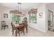 Bright dining area featuring tile flooring, table with seating, and large windows at 21912 E Desert Hills Dr, Queen Creek, AZ 85142