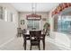 Bright dining room with large window and an elegant chandelier at 21912 E Desert Hills Dr, Queen Creek, AZ 85142