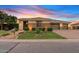 Charming single-story home featuring a three car garage and lush lawn at 21912 E Desert Hills Dr, Queen Creek, AZ 85142
