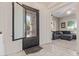 Spacious foyer featuring tile flooring, an ornate iron door and access to the living room at 21912 E Desert Hills Dr, Queen Creek, AZ 85142
