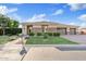 Beautiful home with well-manicured lawn, lush landscaping, and a three car garage at 21912 E Desert Hills Dr, Queen Creek, AZ 85142