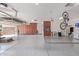 Clean and organized garage area featuring epoxy floors and built-in storage cabinets at 21912 E Desert Hills Dr, Queen Creek, AZ 85142