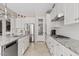 Bright and modern kitchen with granite counters, white cabinets, and stainless appliances at 21912 E Desert Hills Dr, Queen Creek, AZ 85142