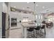 Modern kitchen featuring stainless steel appliances, an island with seating, and white cabinetry at 21912 E Desert Hills Dr, Queen Creek, AZ 85142